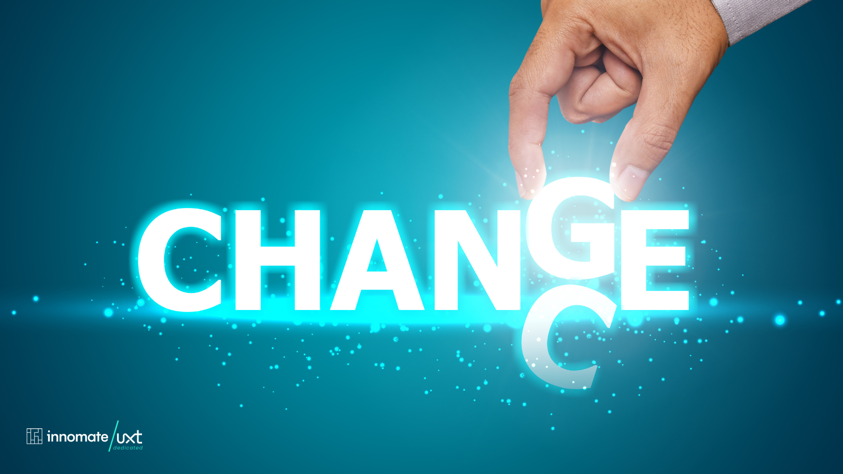 Innomate/UXT: A hand rearranges a letter spelling 'CHANGE' to form the word 'CHANCE' on a blue background, symbolising the opportunity within change.